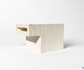 The same model photographed from a low three-quarter angle on white, with soft even light